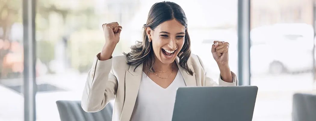 Happy employee celebrating at their desk