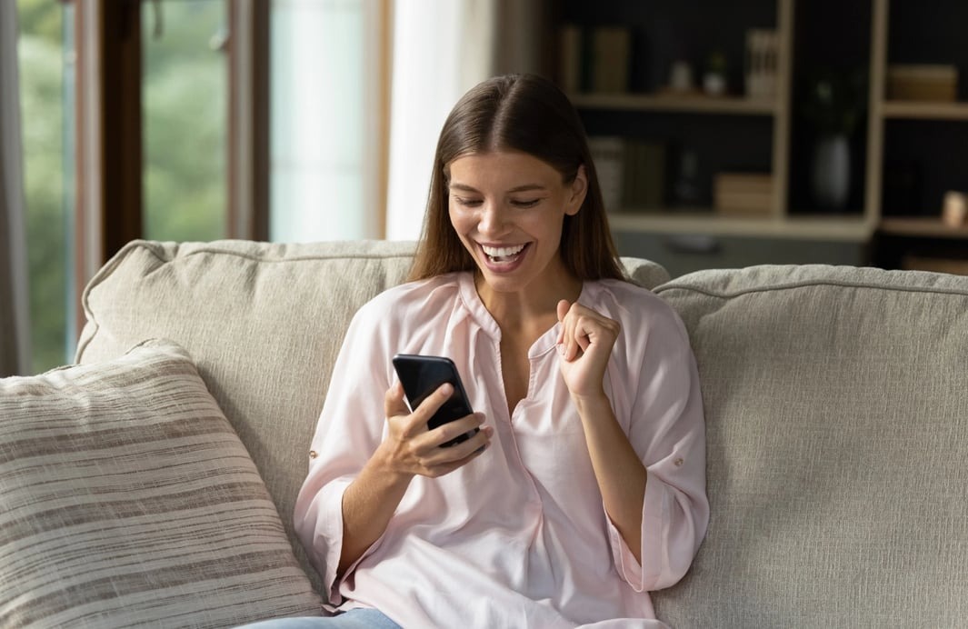 Woman enjoying a customer incentive scheme on her phone